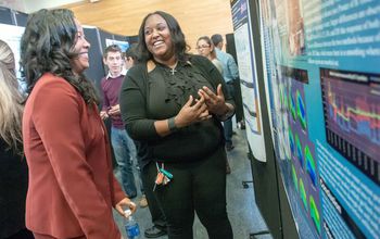 A Garden State LSAMP scholar explains her research poster to a visiting NSF program officer.